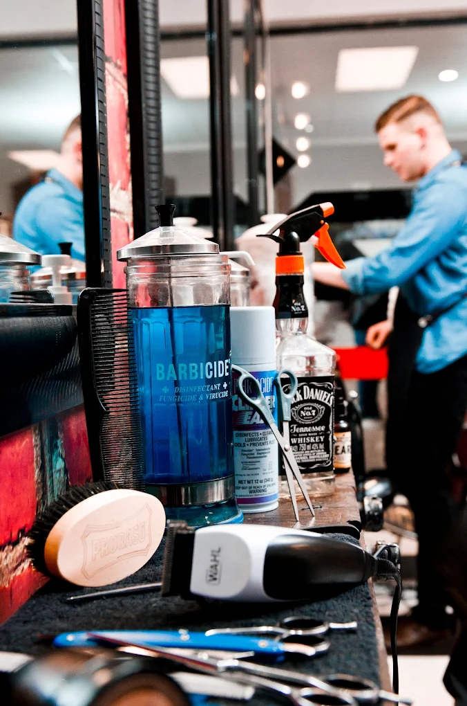 Barber station with Barbicide, clippers, and grooming tools