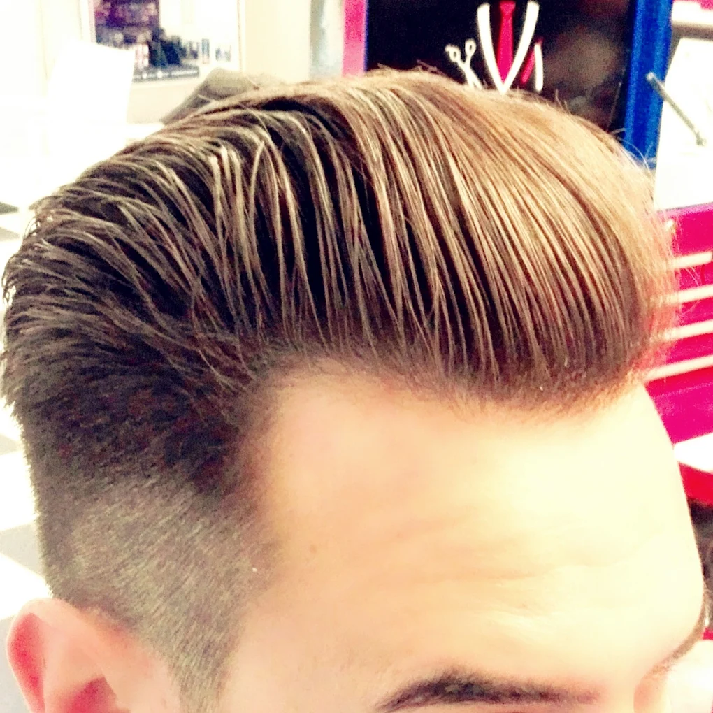 Client with a classic slick back pompadour fade
