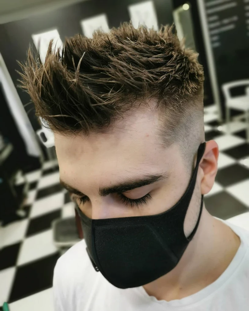 Client with textured spiky modern hair and a skin fade