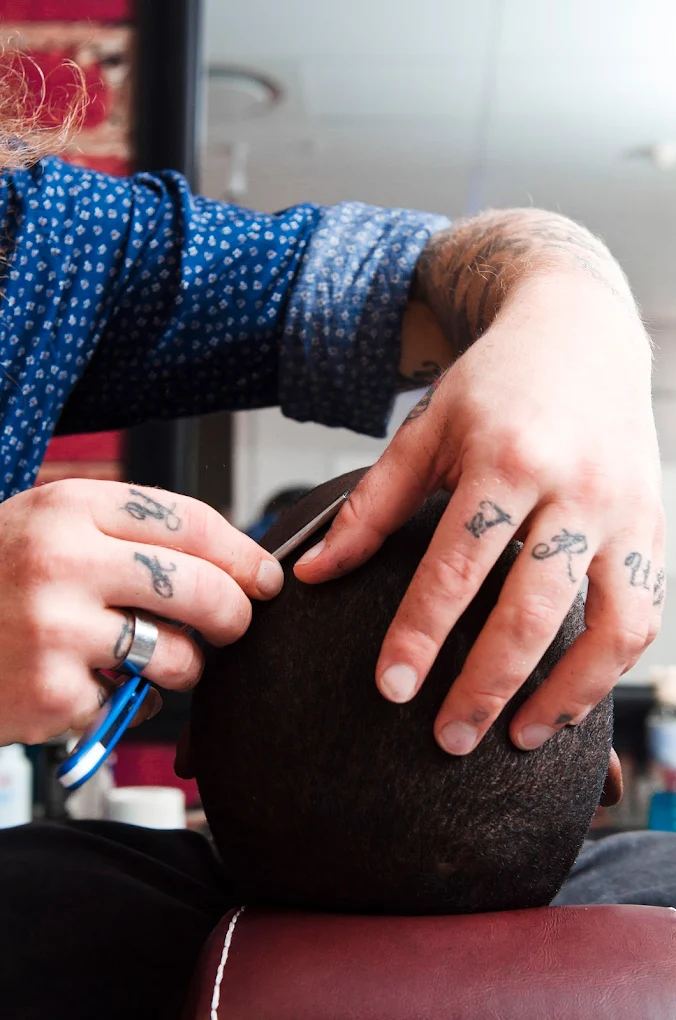 Barber expertly cutting hair with scissors